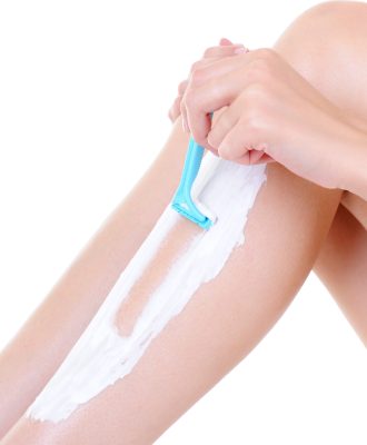 depilation with razor on the female legs - part of leg close-up
