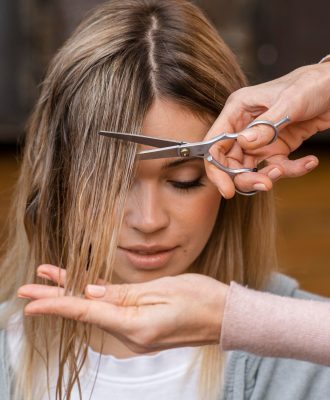 front-view-woman-getting-haircut-home