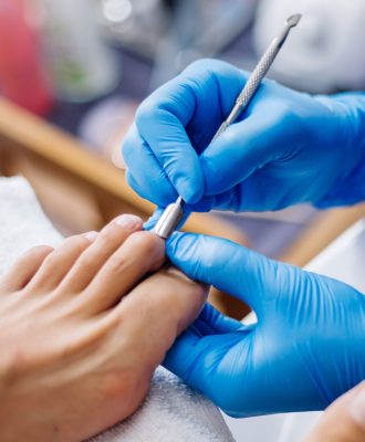 pedicure-process-home-salon-pedicure-foot-care-treatment-nail-process-professional-pedicures-master-blue-gloves-make-pedicure