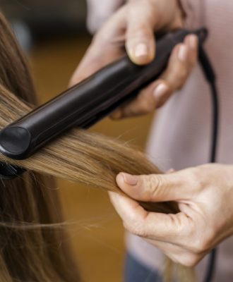woman-getting-her-hair-straightened-home